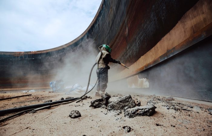 Female Worker Surface Corrosion Plate Preparation By Sand Blasting Of